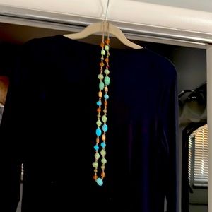A women’s long single strand beaded necklace